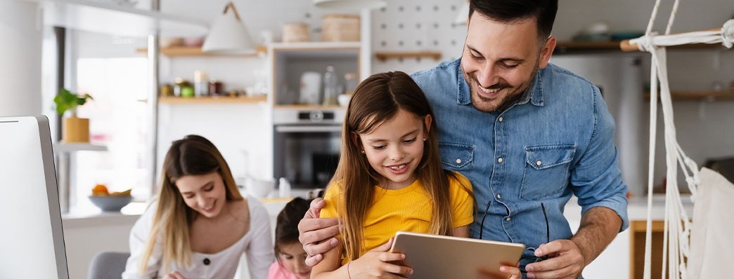 Family in a DIY room while working on projects and looking at their tablet