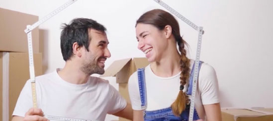 Man and woman posing with some boxes