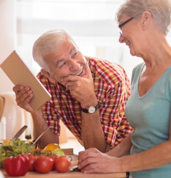 Retired older couple talking in the kitchen