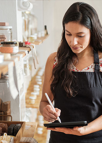 Woman in a store taking inventory on her tablet