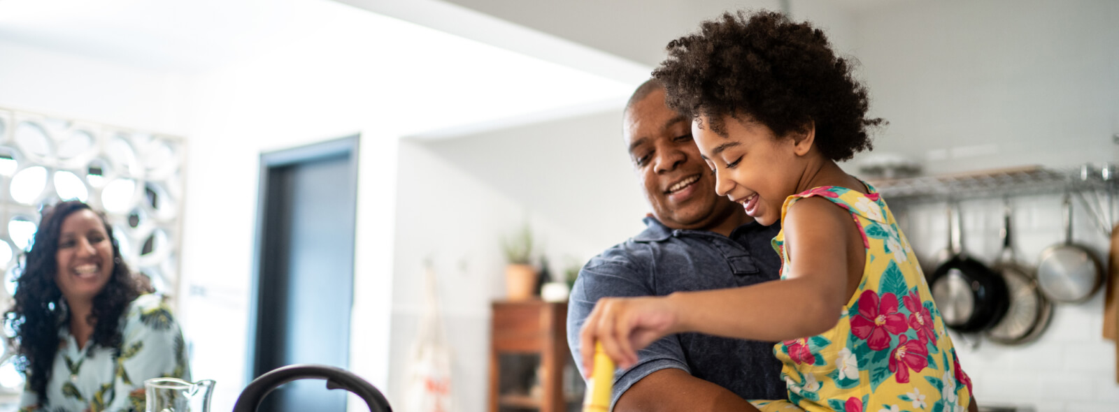 Young girl helping parents make dinner