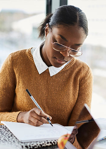 Woman budgeting in a notebook