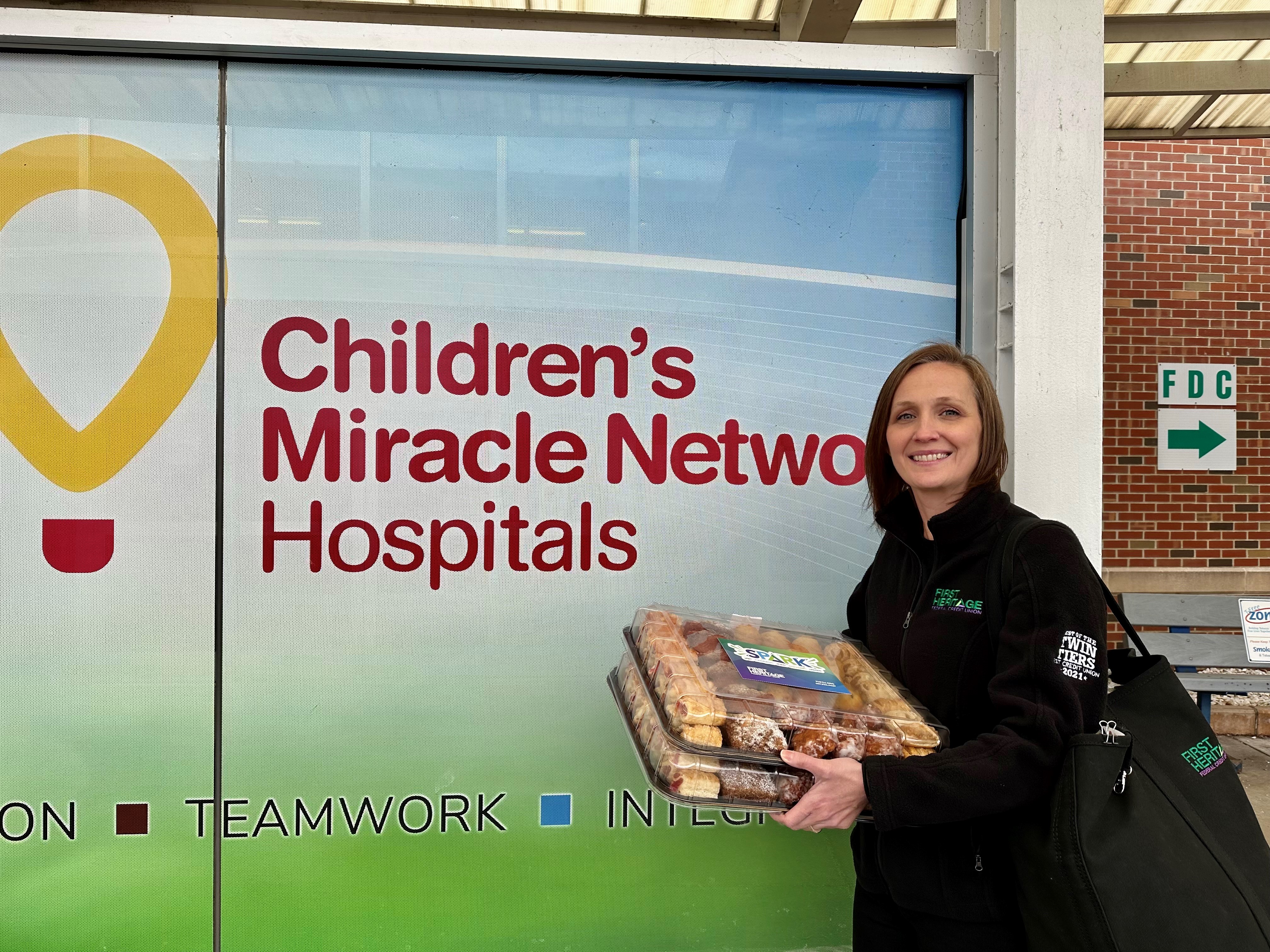 Christy in front of Children's Miracle Network sign