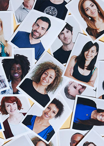 A collection of headshots spread out on a table