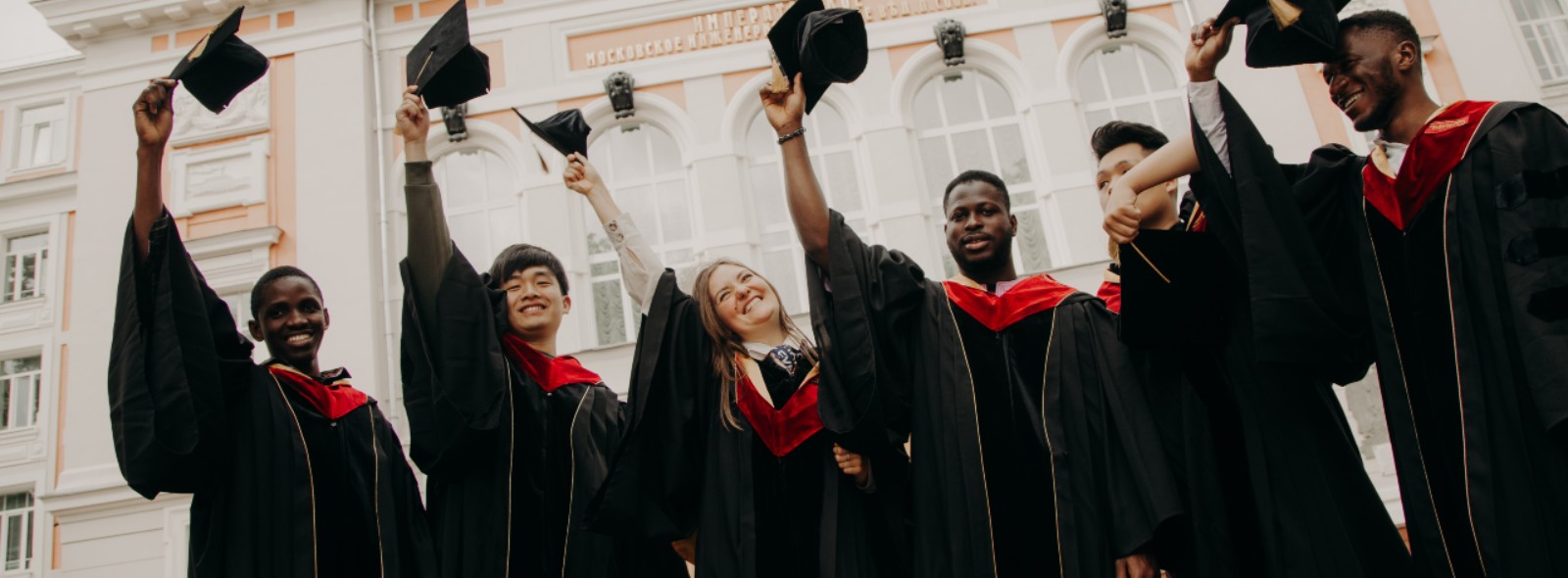 Graduates throwing their caps