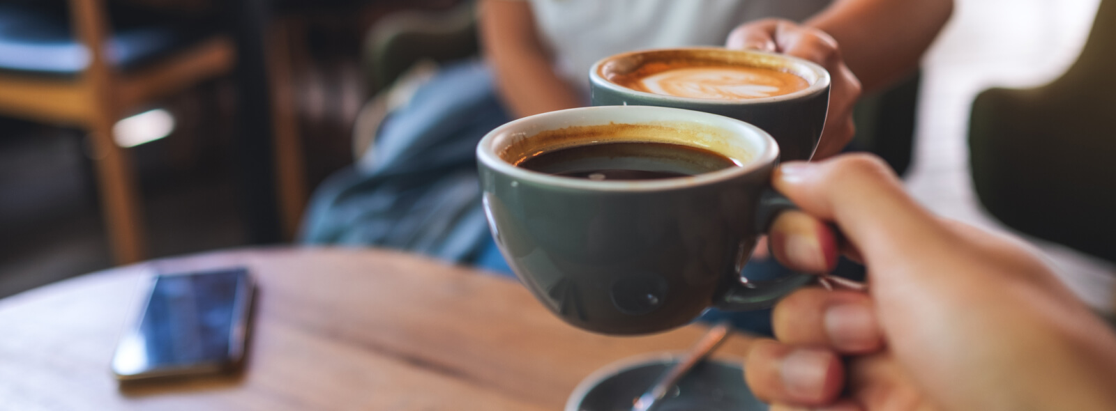 Two coffee cups being cheers'd