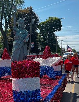 First Heritage Federal Credit Union patriotic float for Memorial Day featuring the Statue of Liberty