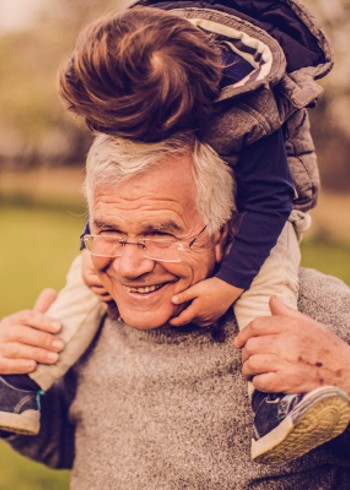 Grandfather with his grandson on his shoulders