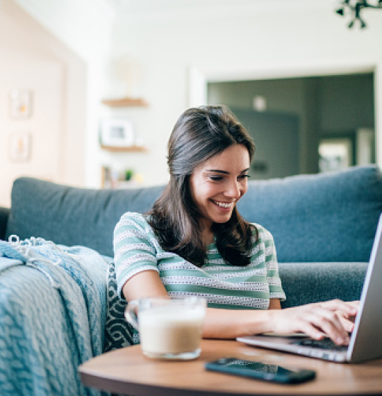 Young woman using laptop in living room