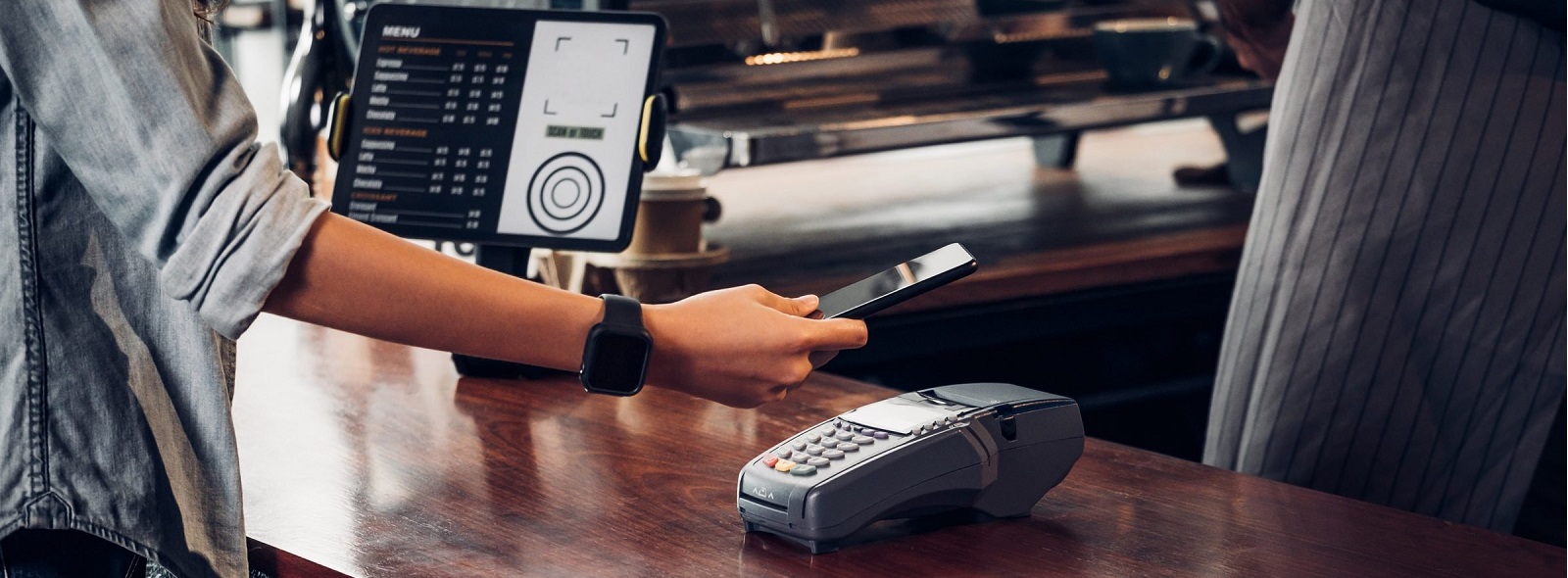 person using their mobile wallet to pay at a cashier