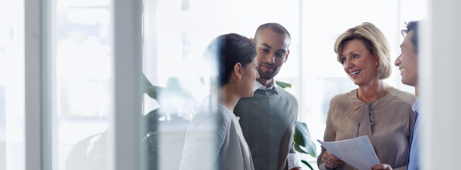 Group of businesspeople chatting in office