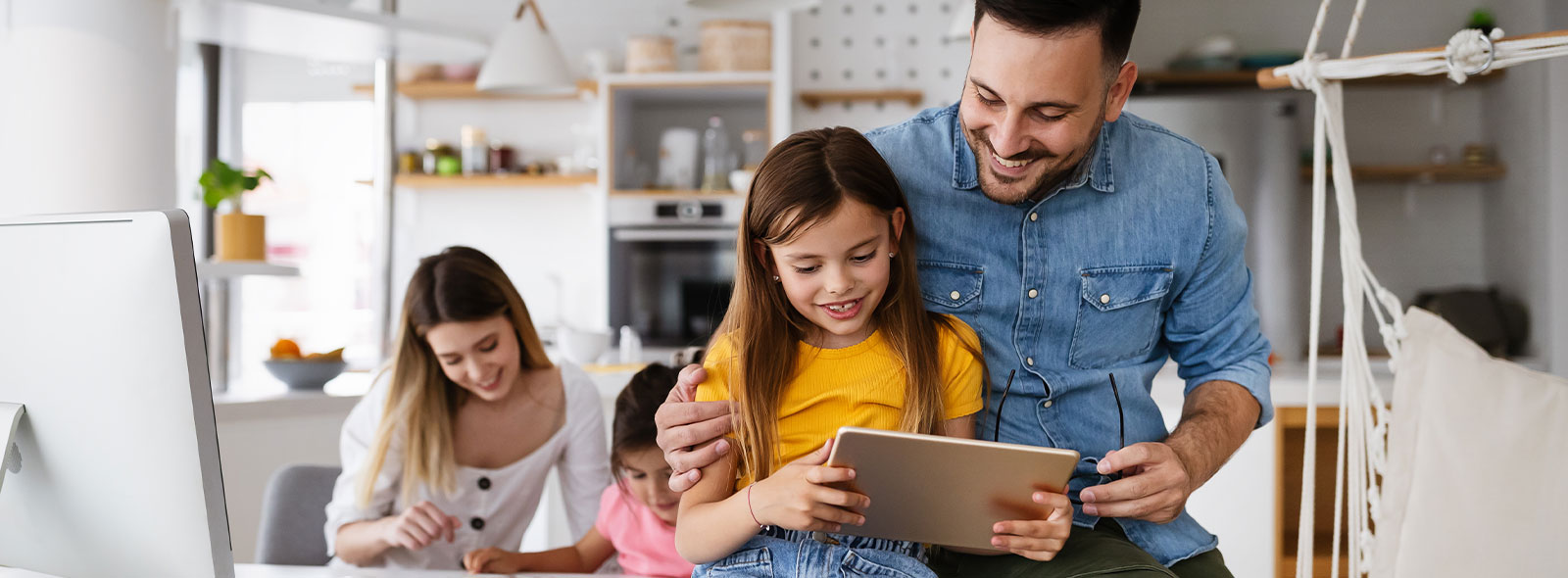 Family in a DIY room while working on projects and looking at their tablet